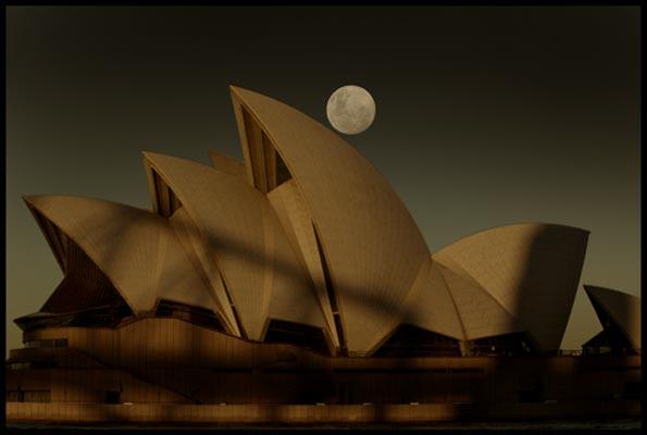 Opera House at dusk with the full moon rising behind it