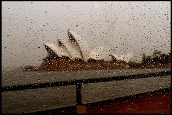 Opera House in the rain, as seen through a ferry window covered in rain drops