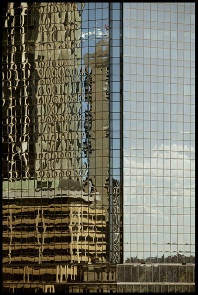 City buildings reflected into windows of AXA building at Circular Quay