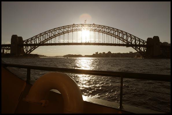 on the ferry from Manly with a setting sun behind the Harbour Bridge