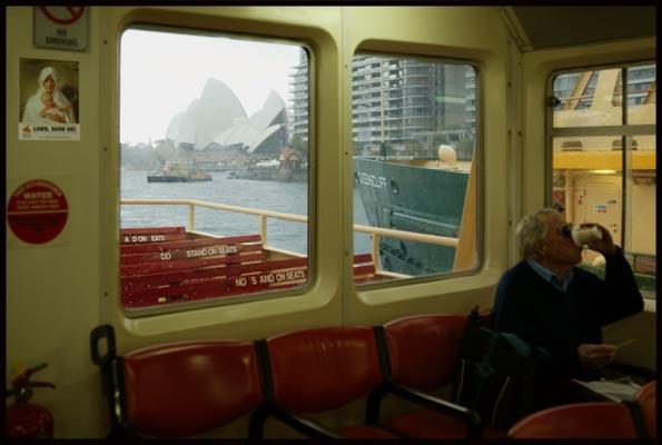 On the ferry with the Opera House seen through a window