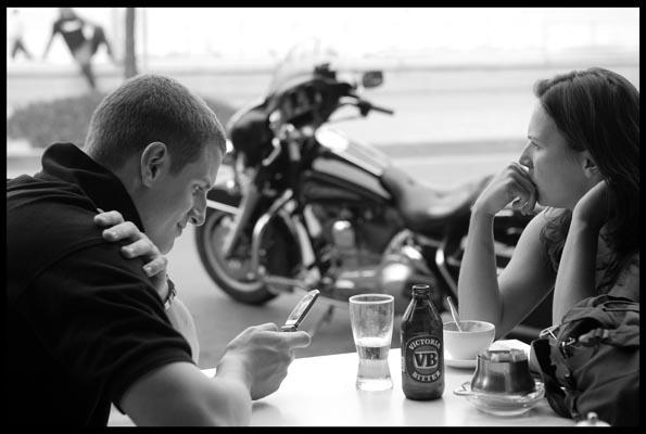 a couple relax in a café at Manly Beach