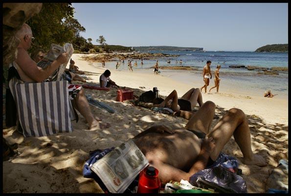 people relaxing in the shade at Balmoral Beach on Christmas Day