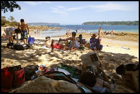 people relaxing in the shade at Balmoral Beach on Christmas Day