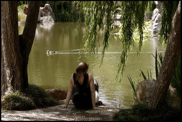 Woman relaxing by the pond, Chinese Garden of Friendship, Darling Harbour